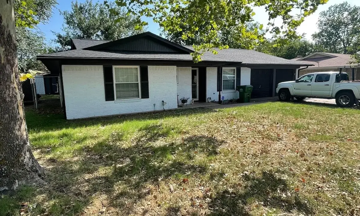 Professional roofing crew working on a residential roof in East Highland Park